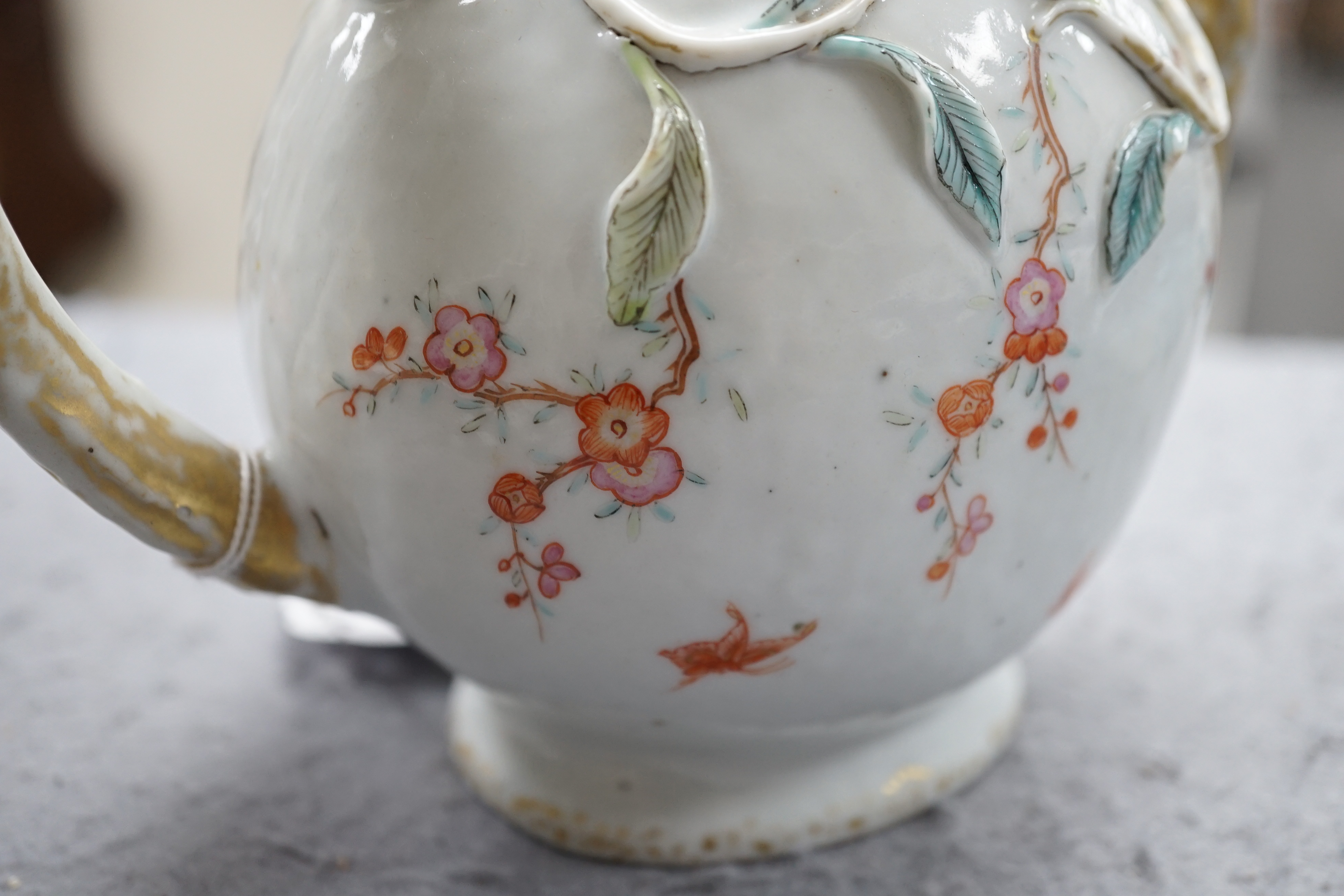 A Chinese enamelled porcelain peach-shaped teapot, Qianlong period (1736-95), wear to gilding